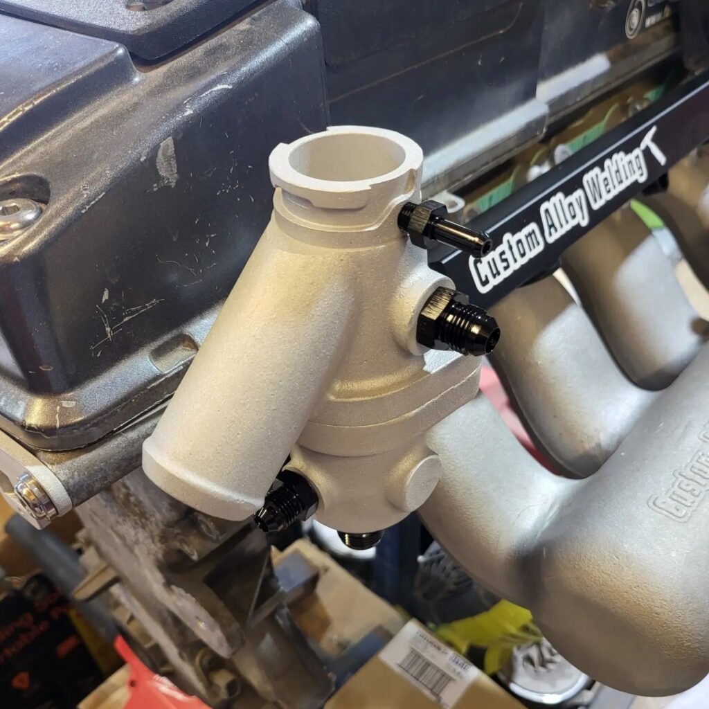 Barra/SOHC Cast front facing thermostat housing with cap Custom Alloy